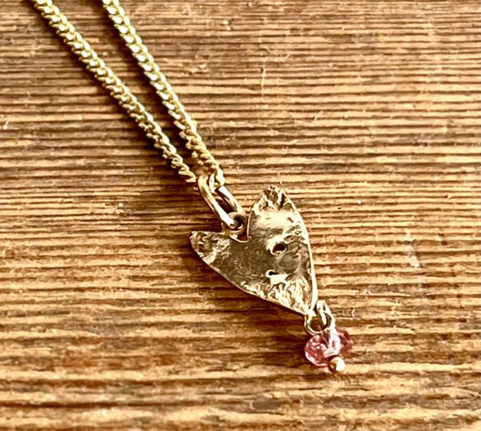 9ct gold sharp heart with pink tourmaline and 40cm chain (10).   Jewellery by Holly Belsher. 9ct gold & tourmaline.